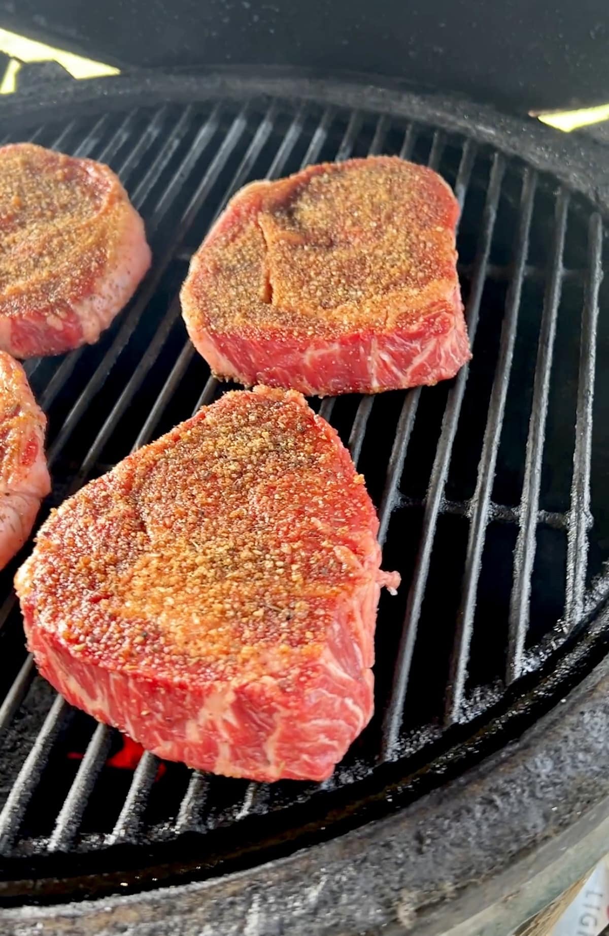 Ribeye steaks on a grill.