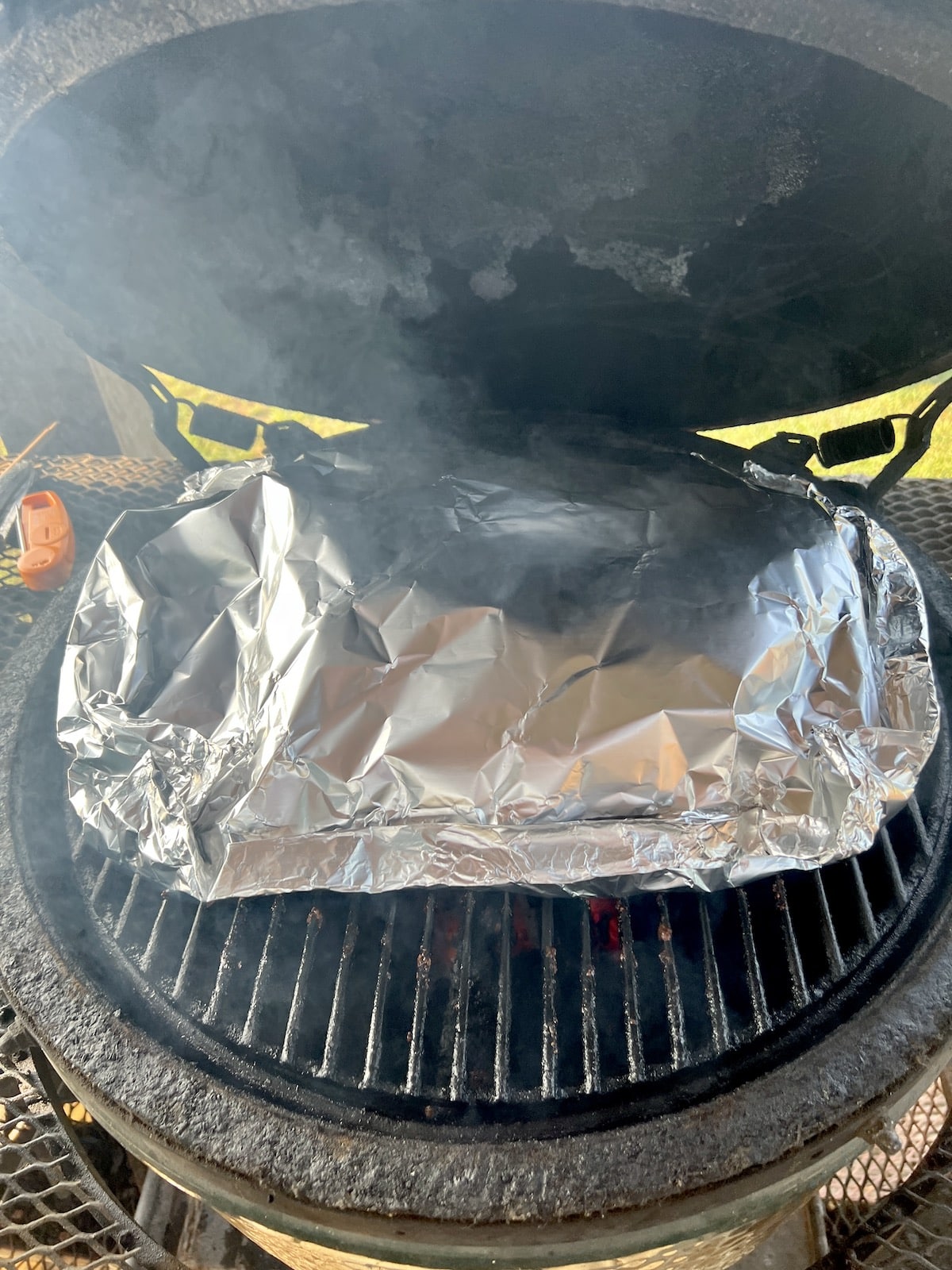 Foil packet party ribs on a grill.