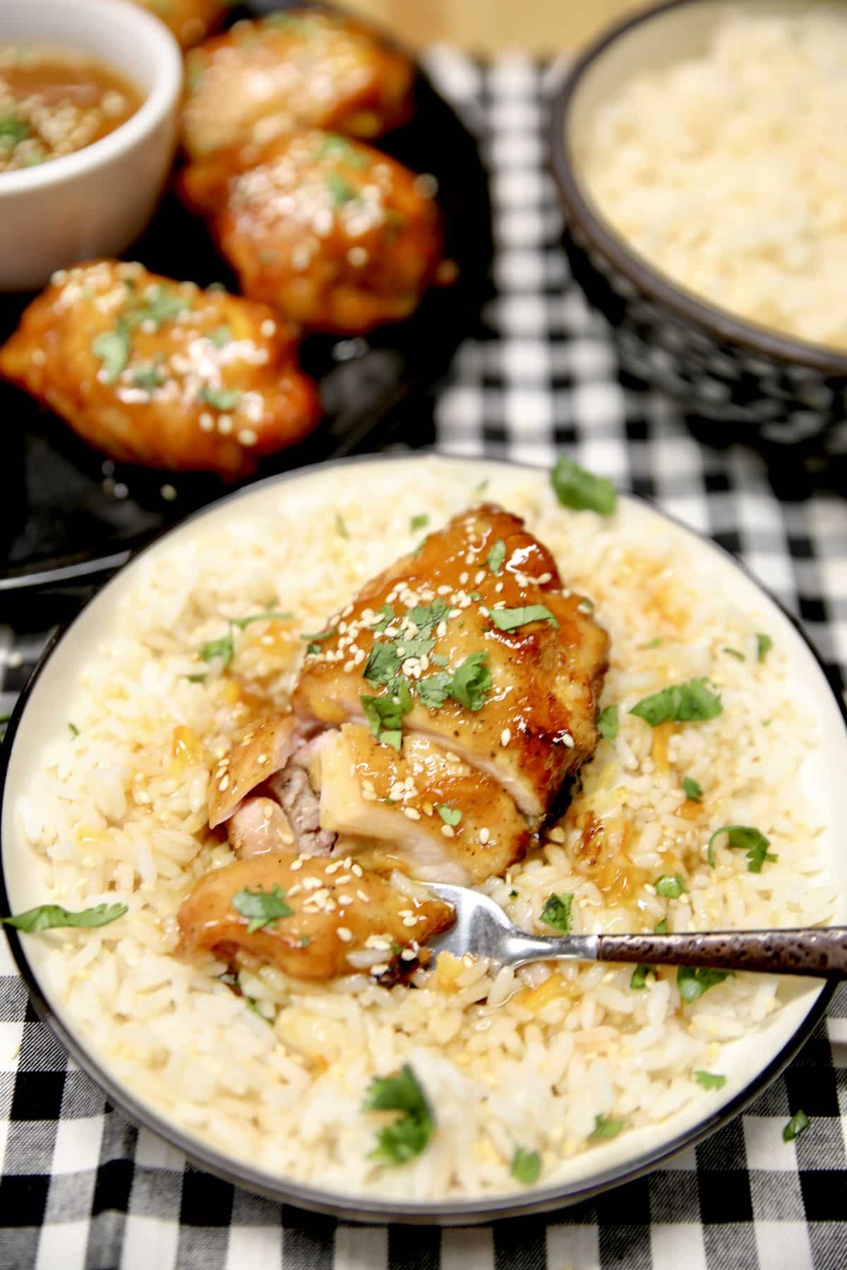 Chicken thigh on a plate with fork. 