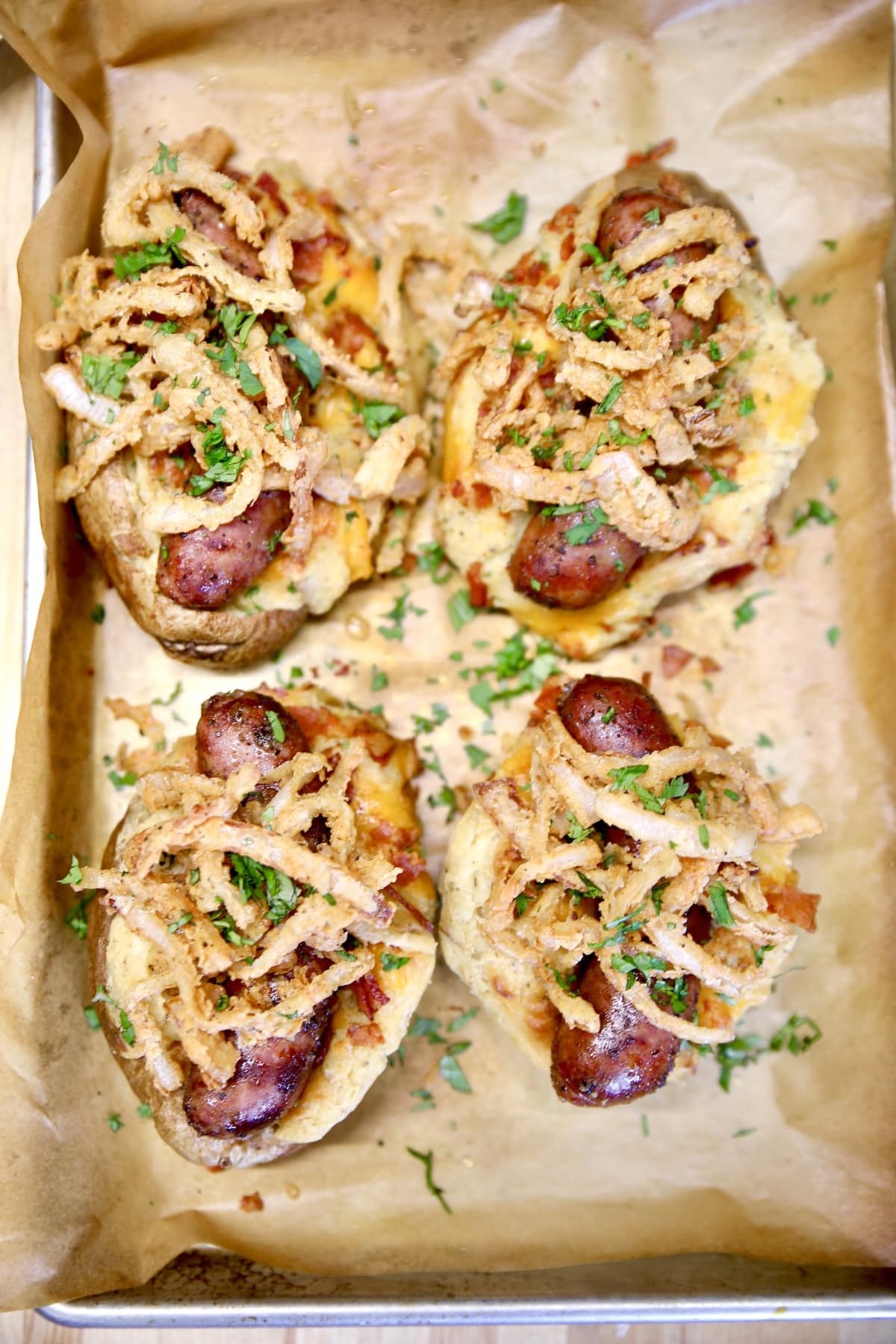 Loaded baked potatoes with sausage and onions.