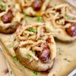 Baked potato stuffed with smoked sausage and topped with crispy onions.