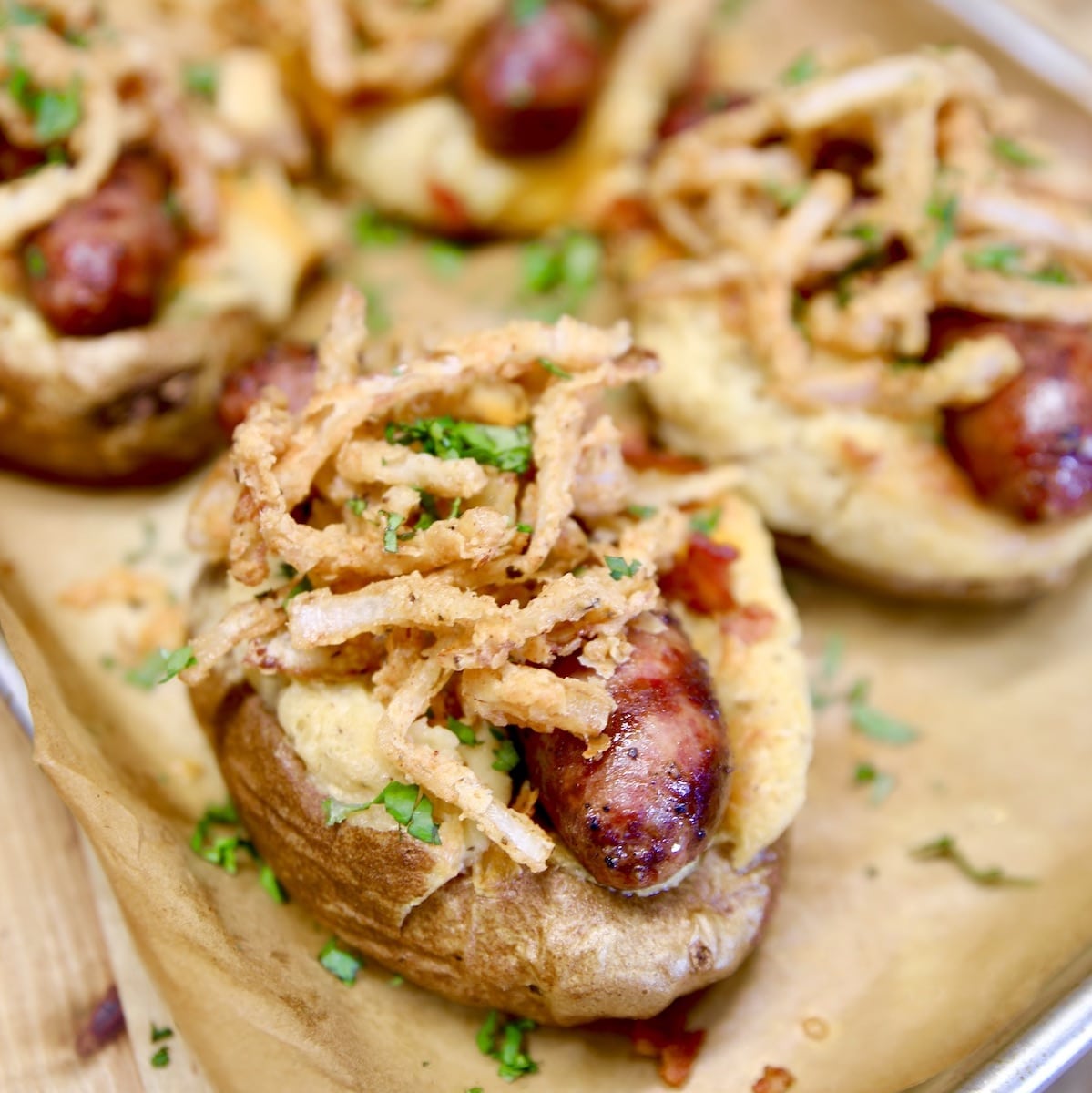 Baked potato stuffed with smoked sausage and topped with crispy onions.