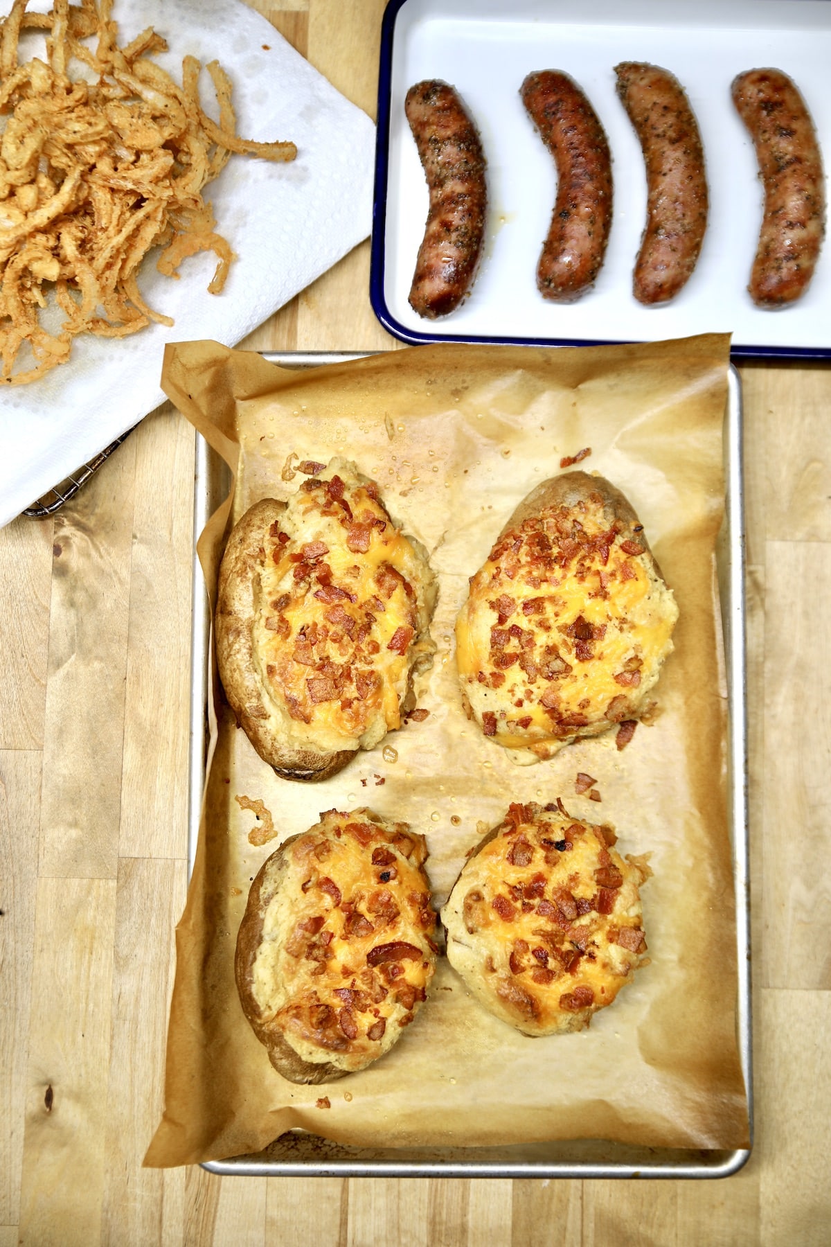 Twice baked potatoes with sausages, onions.