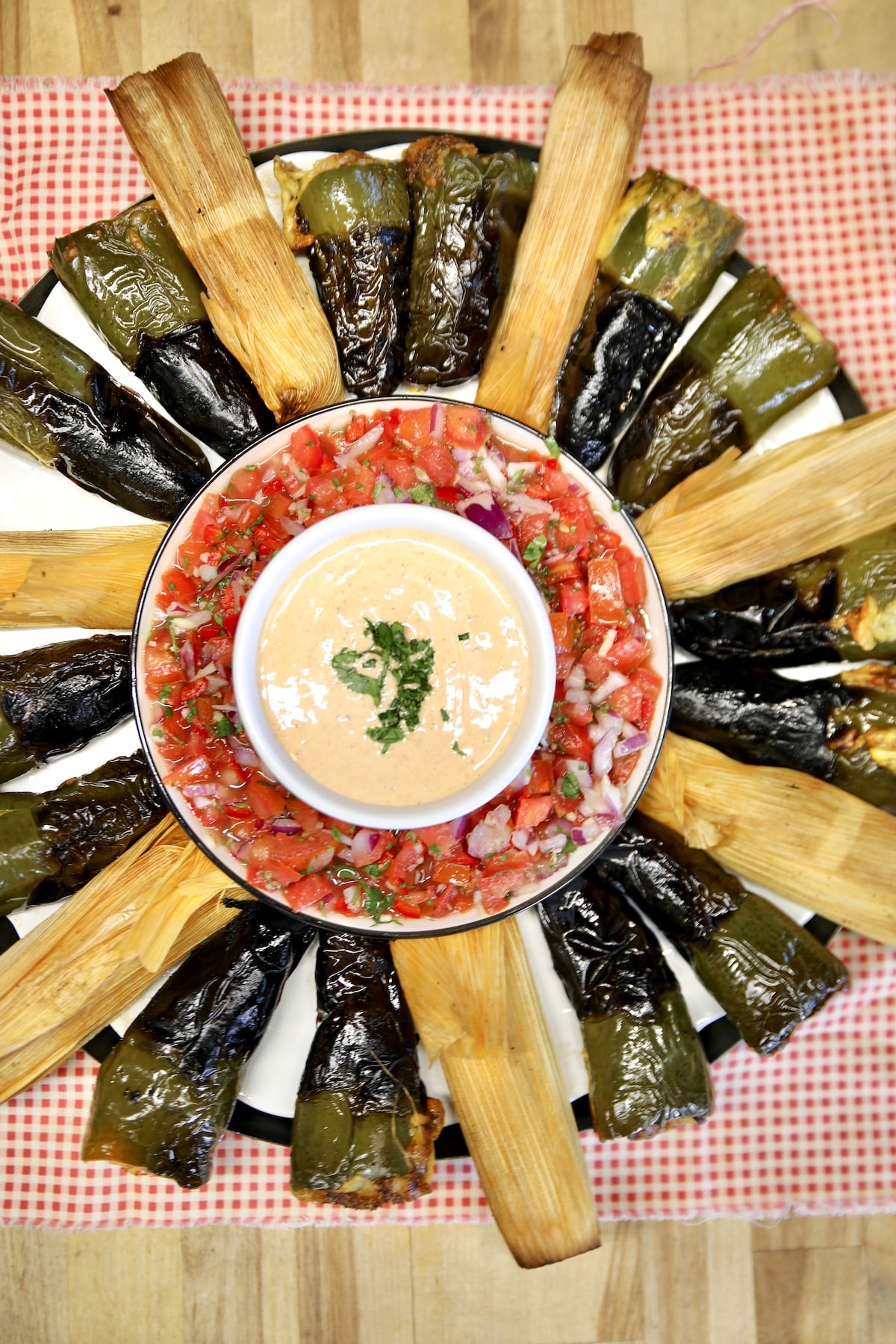 Platter of tamales and jalapeno poppers.