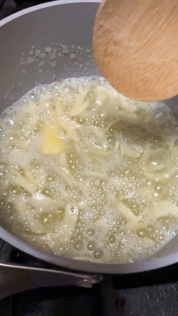 Cooking garlic butter in a pan.