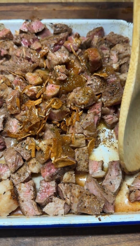 Steak bites drizzled with toasted garlic butter.