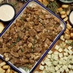 Garlic butter steak bites in a pan with cheese cubes.