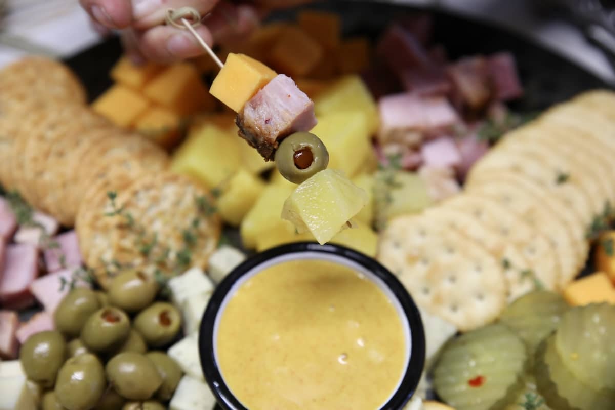 Charcuterie board with leftover ham. Appetizer pick with ham, pineapple, cheese, olive.