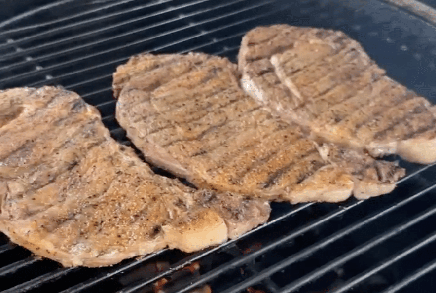 Grilling ribeye steaks.