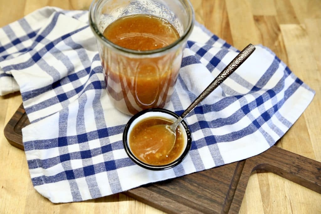 Orange glaze in a jar and sauce bowl.