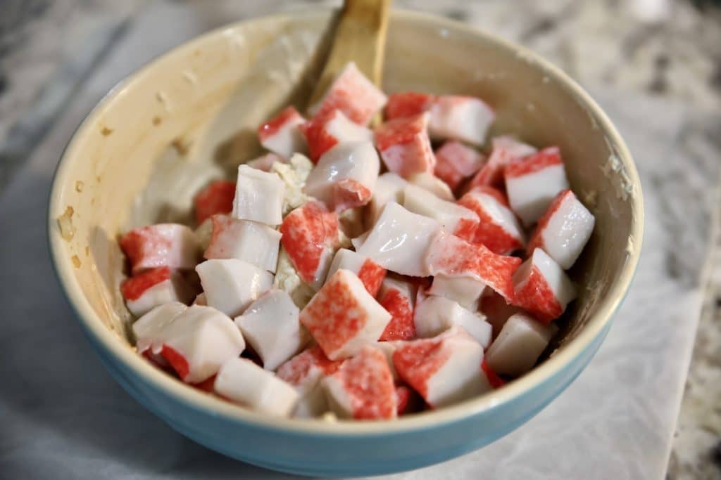 Imitation crab in a bowl with spoon.