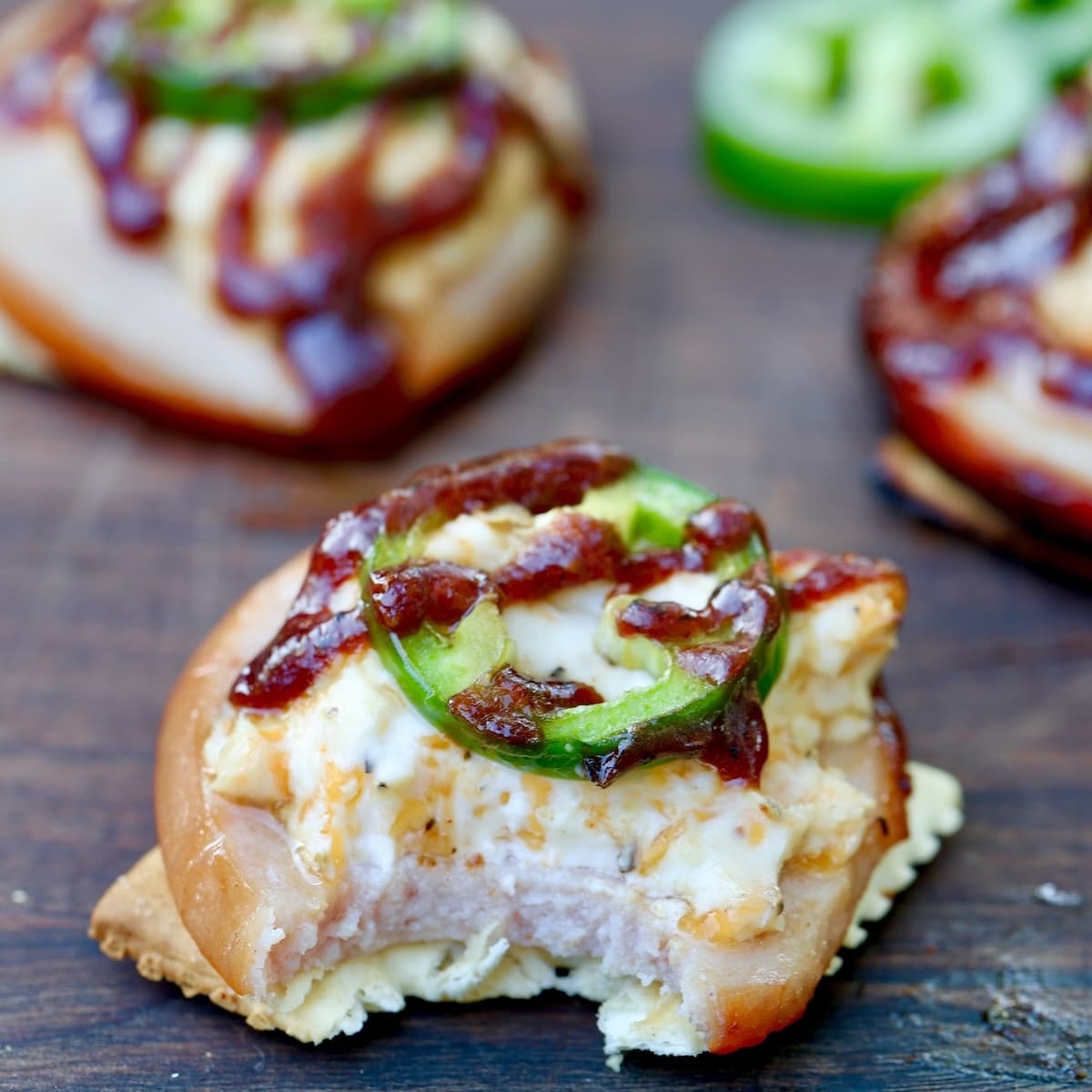 Jalapeno popper bologna cracker appetizer. Cracker with slice of bologna and cream cheese, jalapeno and bbq sauce.