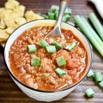 Bowl of chili with green onions.